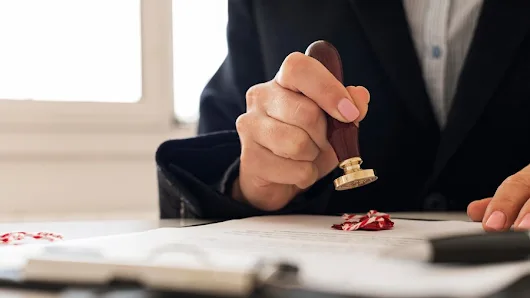 Notary public handling documents in an office setting